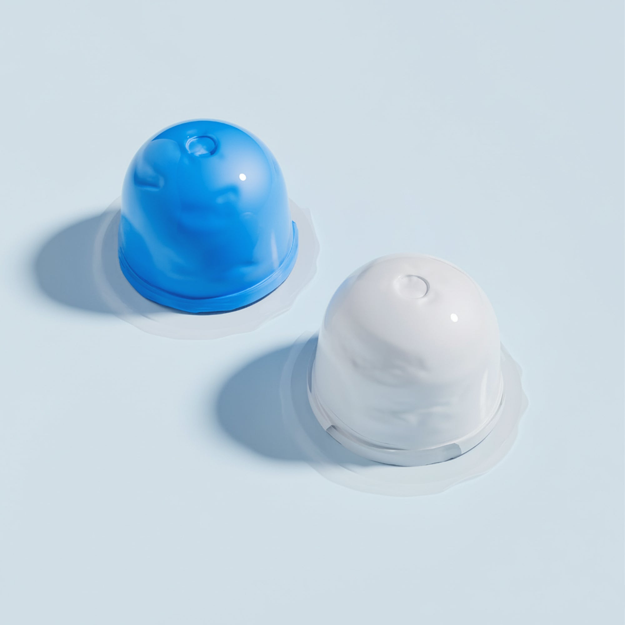 Blue and white dental impression silicone putty pots on light blue background